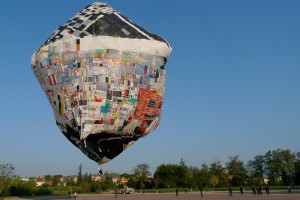 A giant balloon made of old carrier bags floats in the air